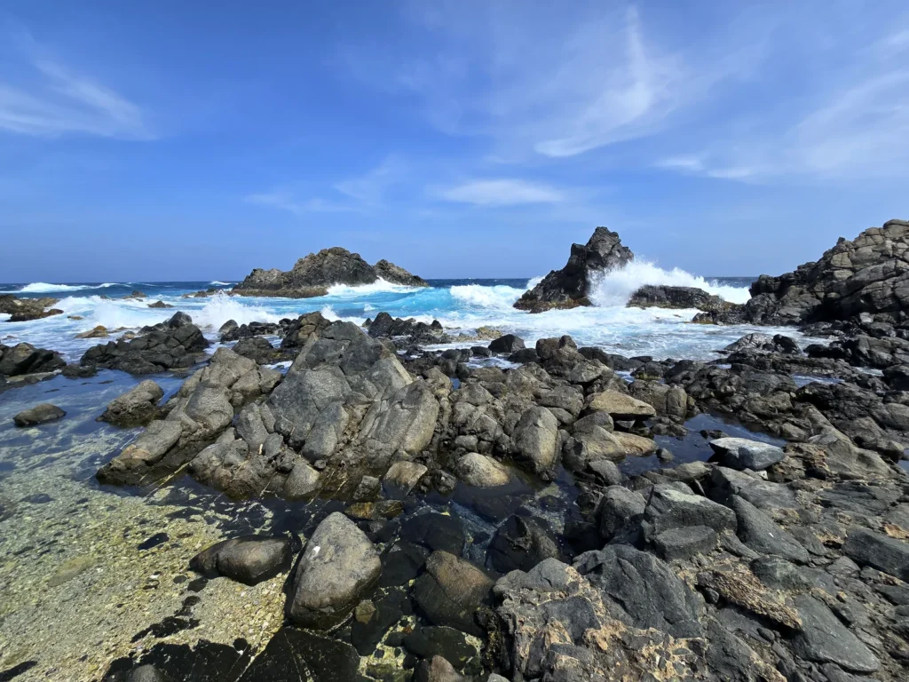 Ruige rotskust en blauwe oceaan in Arikok National Park op Aruba