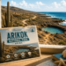 AI-generated illustration of a room overlooking Aruba’s rugged coast and natural pool, with a postcard of Arikok National Park and visitor activities.